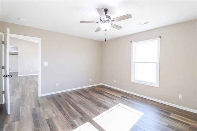 empty room featuring ceiling fan and dark hardwood / wood-style flooring