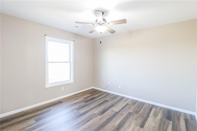 unfurnished room with ceiling fan and dark hardwood / wood-style floors