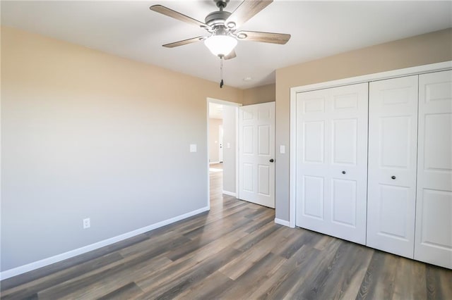 unfurnished bedroom with a closet, ceiling fan, and dark hardwood / wood-style flooring