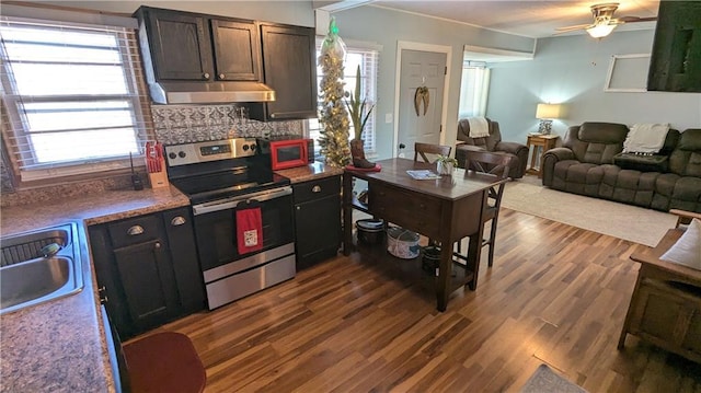 kitchen featuring backsplash, dark wood-type flooring, sink, ceiling fan, and stainless steel electric range oven