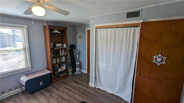 miscellaneous room featuring ceiling fan and dark wood-type flooring