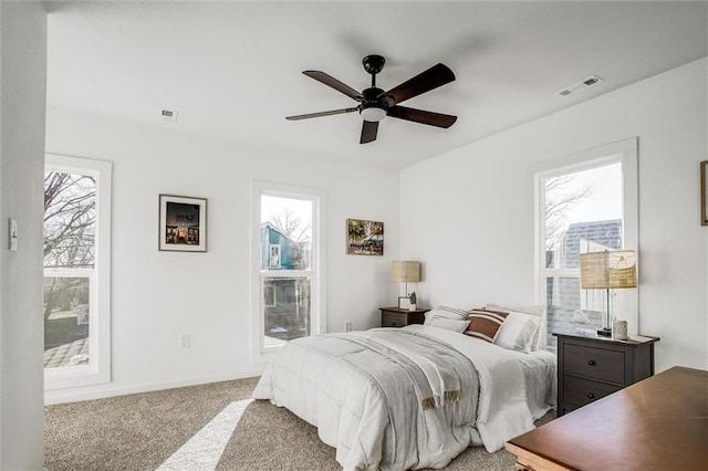 bedroom with carpet flooring, multiple windows, and ceiling fan