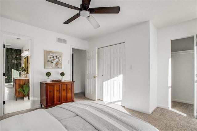 bedroom with ensuite bath, ceiling fan, and light carpet