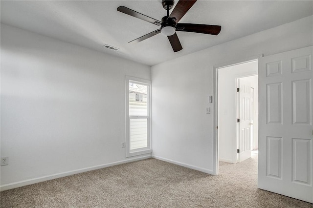 carpeted empty room featuring ceiling fan