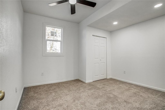 carpeted empty room featuring ceiling fan