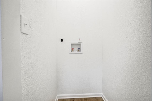 washroom featuring hardwood / wood-style flooring, electric dryer hookup, and washer hookup