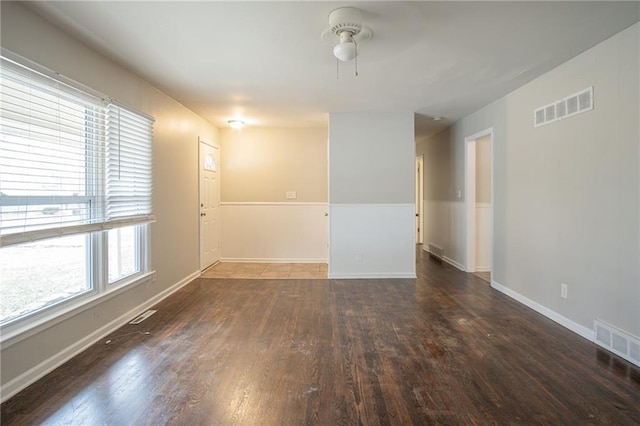 unfurnished room with ceiling fan and dark wood-type flooring