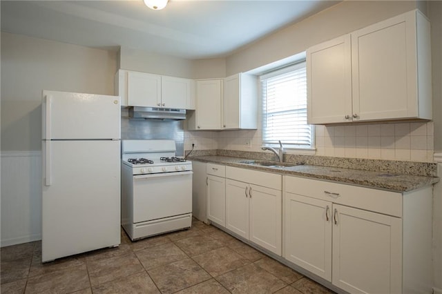 kitchen with decorative backsplash, sink, white cabinets, and white appliances