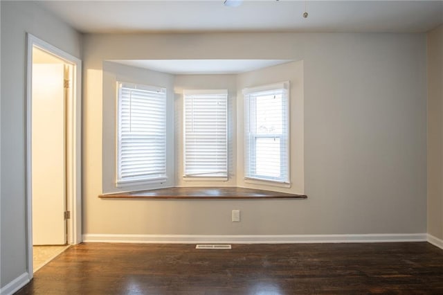 spare room with dark hardwood / wood-style floors