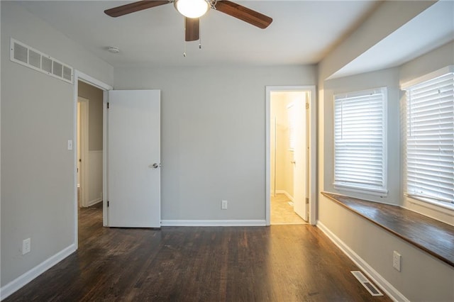 unfurnished bedroom with dark hardwood / wood-style floors, ceiling fan, and ensuite bathroom