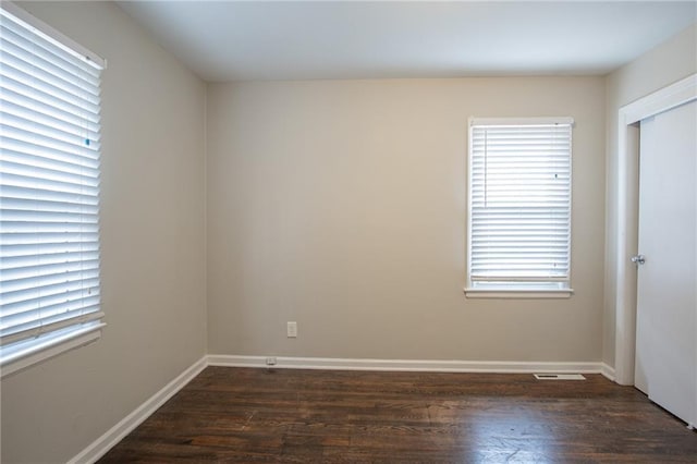 unfurnished room featuring dark hardwood / wood-style flooring