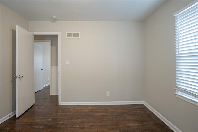 spare room with dark hardwood / wood-style floors