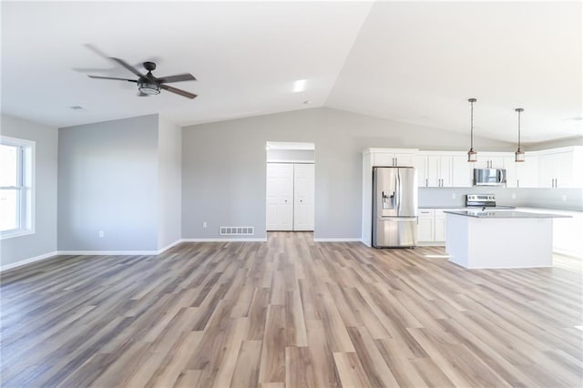 unfurnished living room featuring light hardwood / wood-style floors, ceiling fan, and lofted ceiling