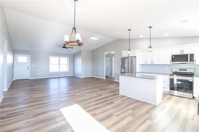 kitchen featuring stainless steel appliances, white cabinetry, and light hardwood / wood-style flooring