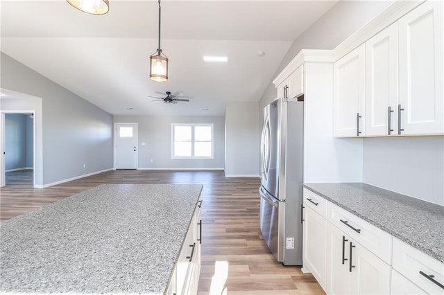 kitchen featuring stainless steel refrigerator, white cabinets, and light hardwood / wood-style floors