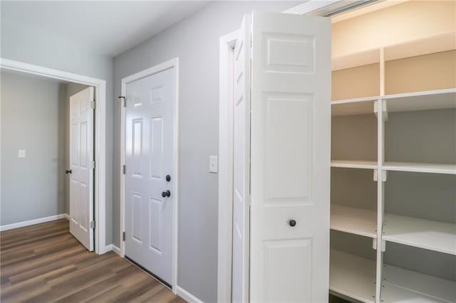 corridor featuring dark hardwood / wood-style flooring