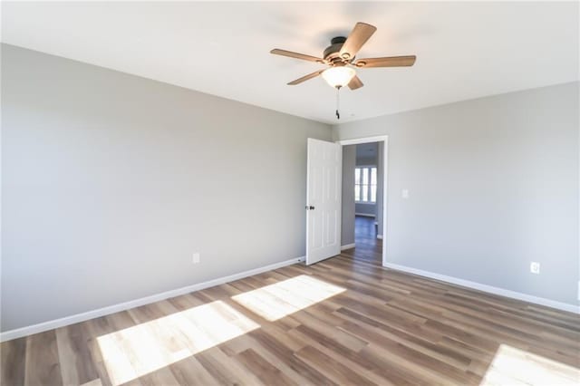 unfurnished room featuring ceiling fan and hardwood / wood-style flooring