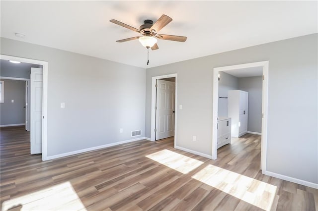 unfurnished bedroom featuring ceiling fan and light hardwood / wood-style floors