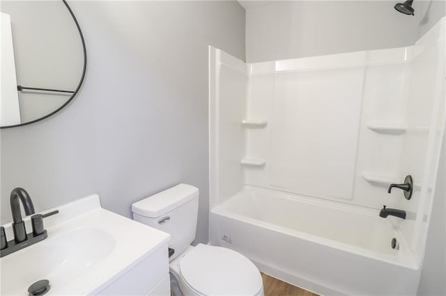 full bathroom featuring hardwood / wood-style floors, vanity, toilet, and bathtub / shower combination