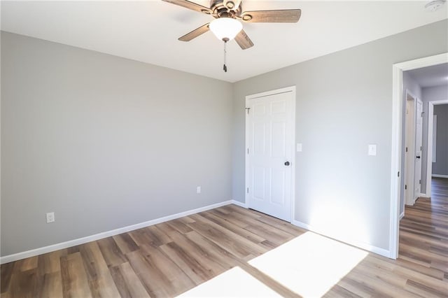 empty room featuring light hardwood / wood-style flooring and ceiling fan