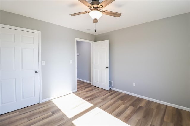 unfurnished bedroom featuring ceiling fan and light wood-type flooring