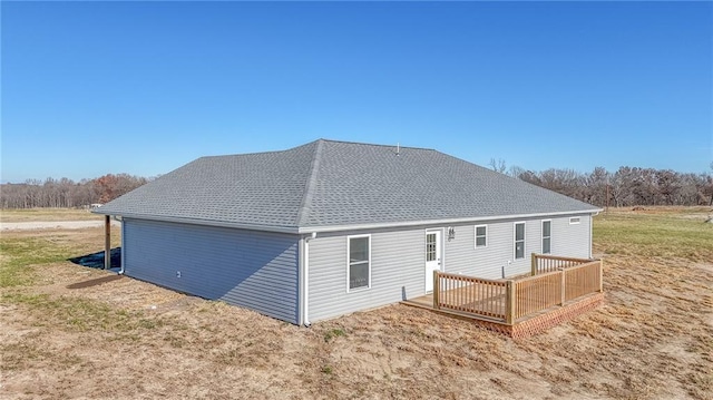 rear view of property featuring a deck