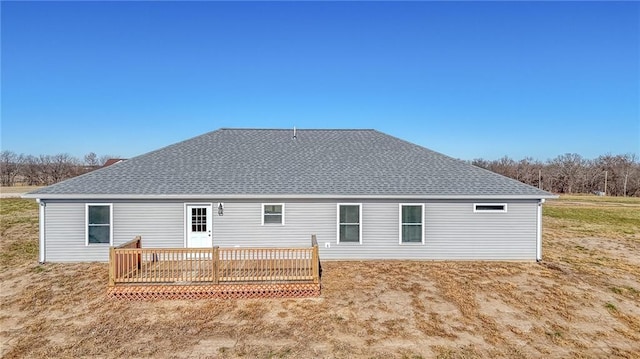 rear view of house featuring a wooden deck