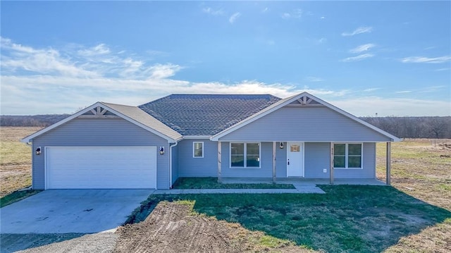 ranch-style house featuring a garage and covered porch