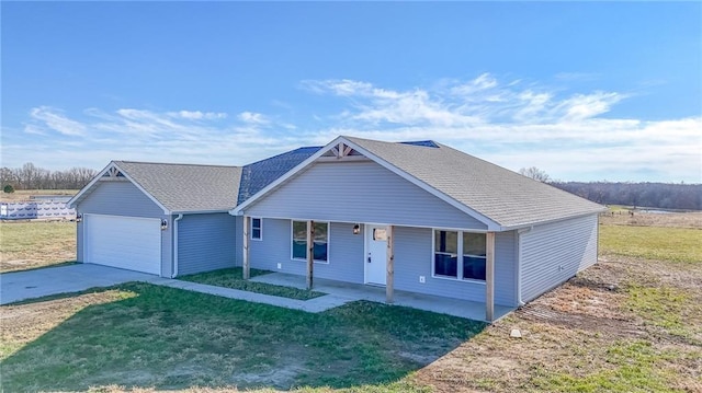 ranch-style house with covered porch, a garage, and a front lawn