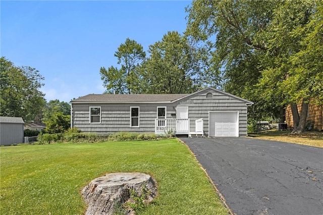 single story home featuring a front yard and a garage