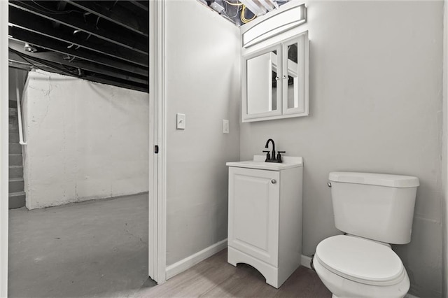 bathroom featuring toilet, concrete flooring, and sink