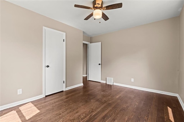 spare room featuring ceiling fan and dark wood-type flooring