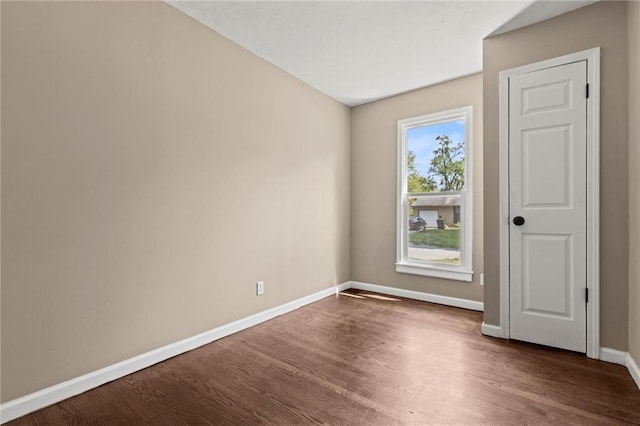 spare room featuring dark wood-type flooring