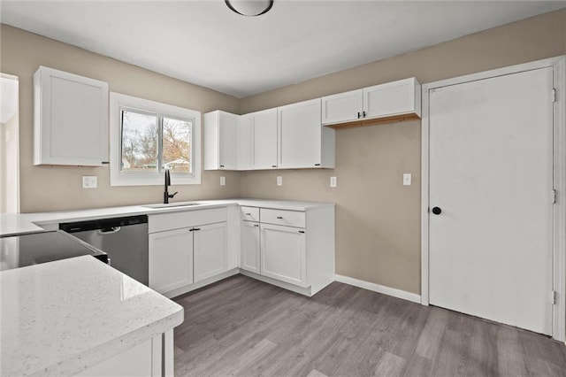 kitchen featuring dishwasher, light hardwood / wood-style floors, white cabinetry, and sink