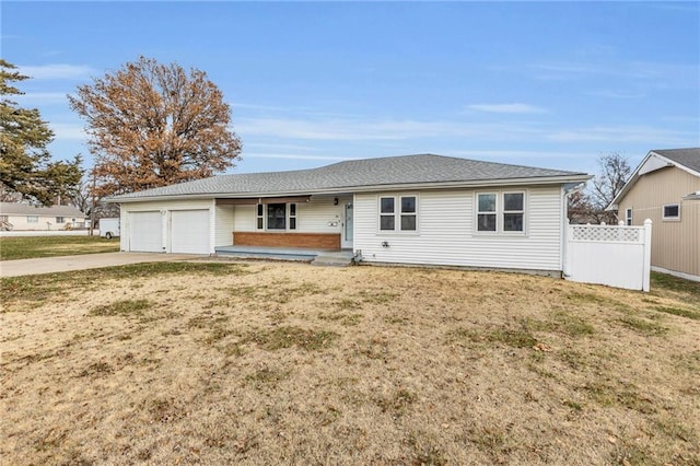 ranch-style home with a garage and a front lawn