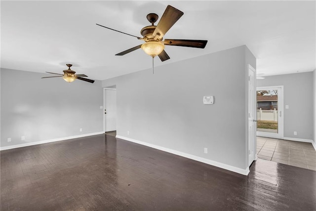 empty room with ceiling fan and dark wood-type flooring