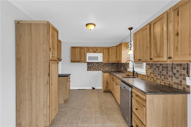 kitchen with dishwasher, sink, tasteful backsplash, pendant lighting, and light tile patterned flooring