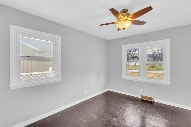 unfurnished room with ceiling fan and dark hardwood / wood-style flooring