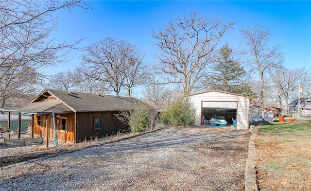 view of side of home featuring an outbuilding and a garage