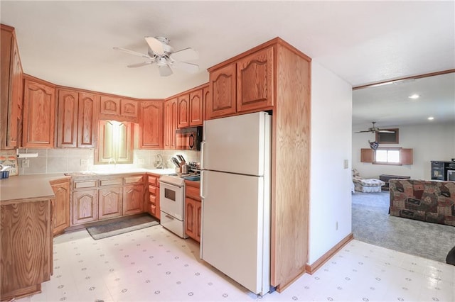 kitchen featuring decorative backsplash, white appliances, light colored carpet, ceiling fan, and lofted ceiling