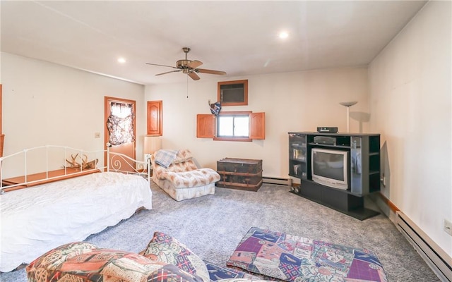 bedroom with carpet floors, ceiling fan, and a baseboard heating unit