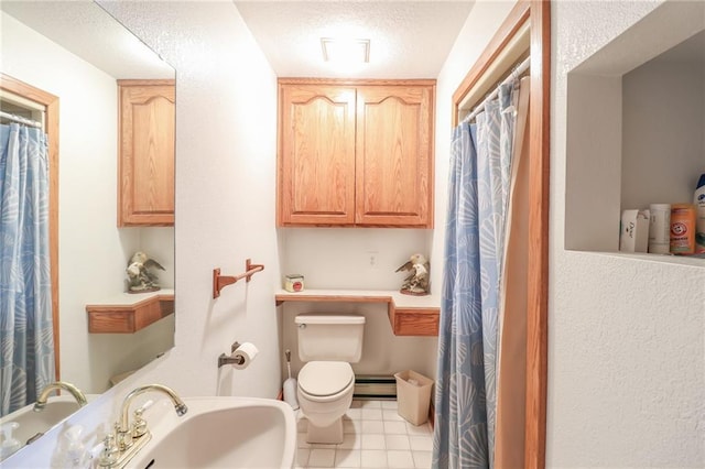 bathroom with sink, a baseboard radiator, a textured ceiling, and toilet