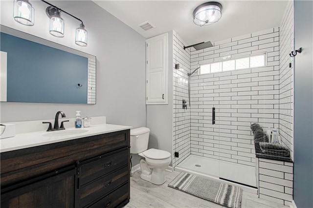 bathroom featuring vanity, hardwood / wood-style floors, toilet, and walk in shower