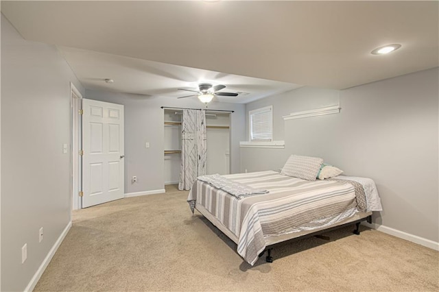 carpeted bedroom featuring a ceiling fan and baseboards