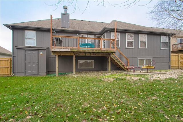 back of property featuring stairway, fence, a wooden deck, a yard, and a chimney