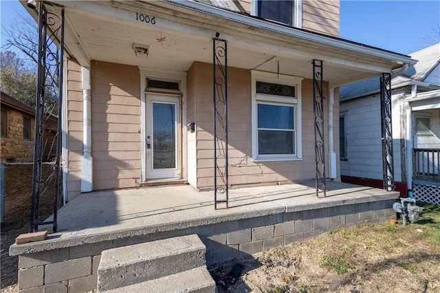 view of exterior entry with covered porch