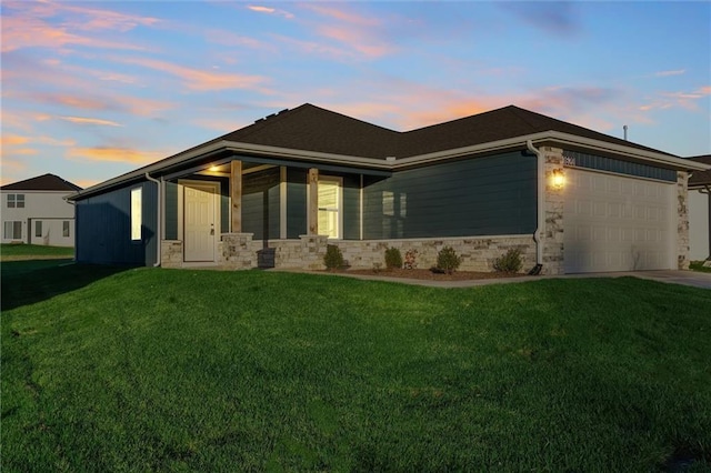 view of front facade with a lawn and a garage