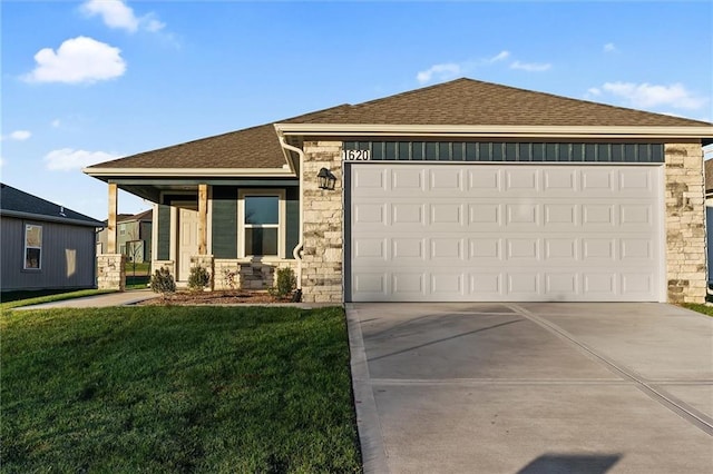 view of front of property with a garage and a front lawn