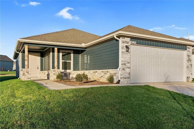 view of front of property with a front yard and a garage