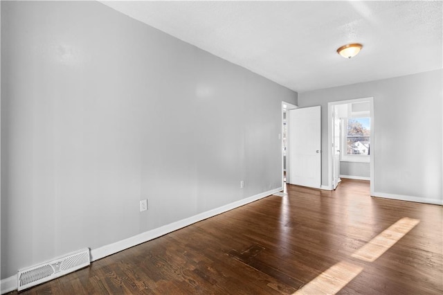 unfurnished room featuring dark hardwood / wood-style floors